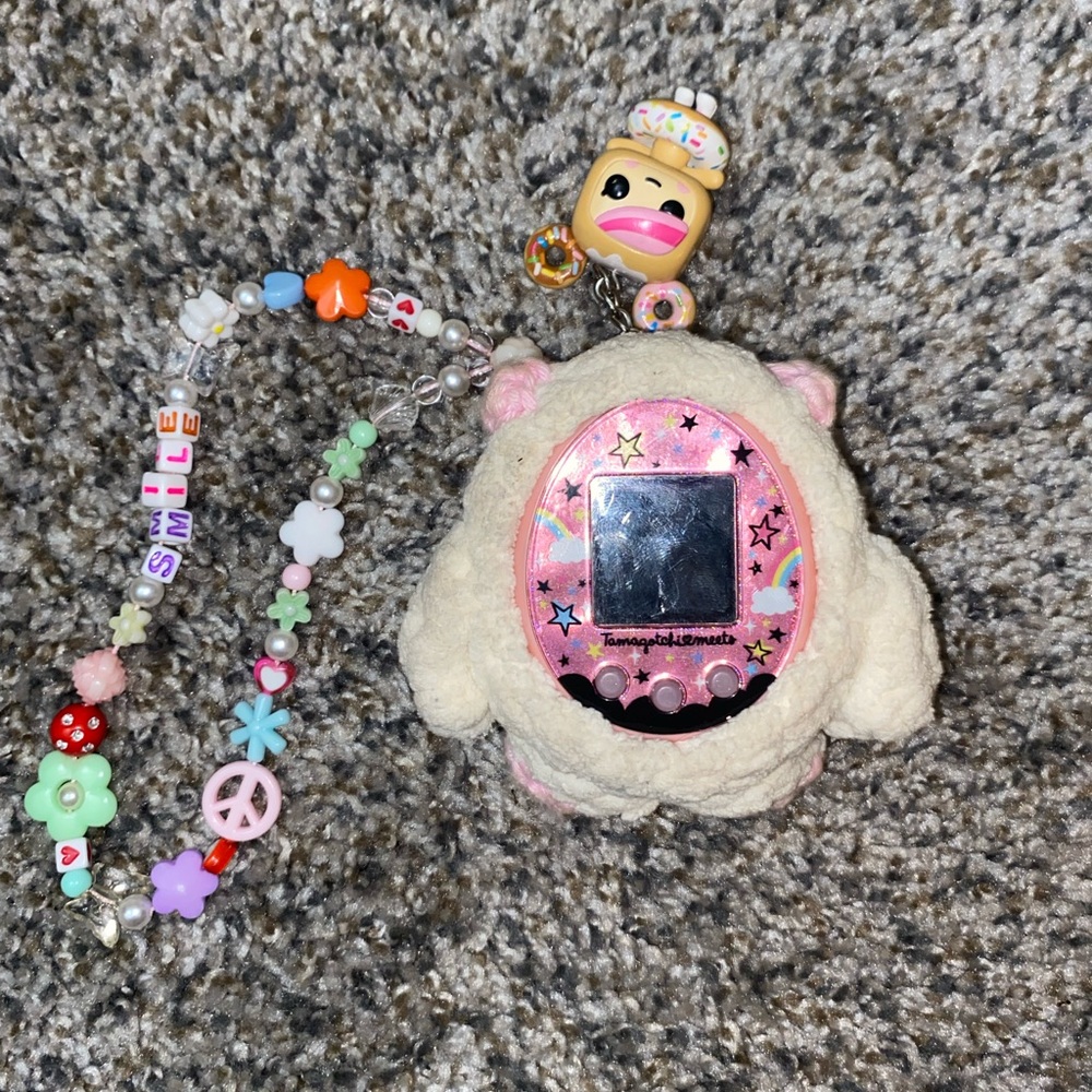 pink tamagotchi meets japanese. pre owned, in good condition.